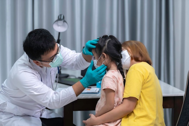 Photo parents bring their daughter to the doctor for influenza vaccinationthe mother brought the child to the doctor at the clinic