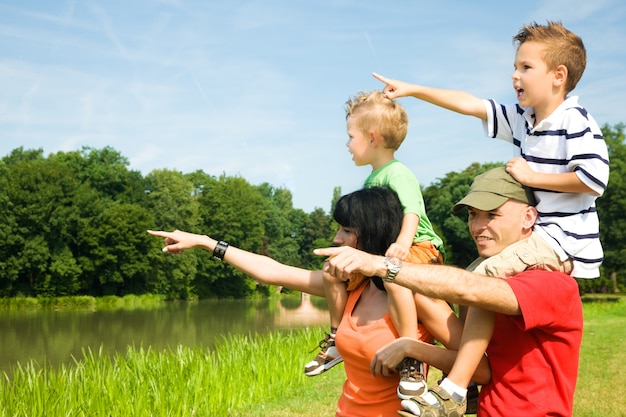 parents carrying their children on their shoulders