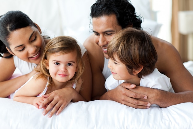 Parents and children lying on the bed 