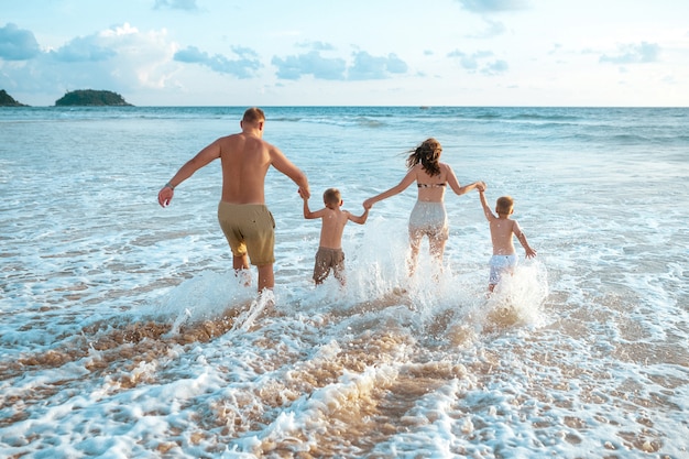 Parents and children running in the water