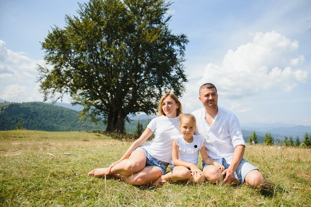 Parents and daughter relaxing in nature