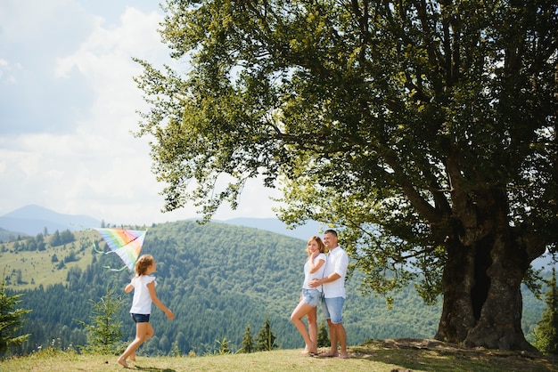 Parents and daughter relaxing in nature