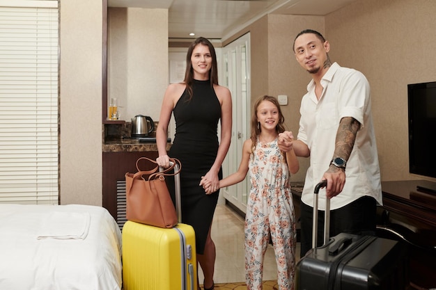 Parents and daughter standing in room of spa resort