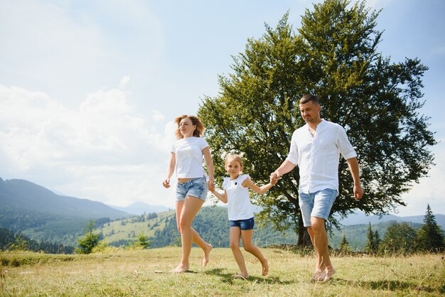 Parents and daughter walking in nature