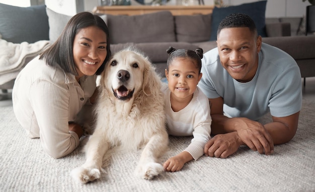 Parents girl and dog on floor portrait and smile with love care and bonding in living room at family home Father mother and daughter with pet animal happiness or relax together on lounge carpet