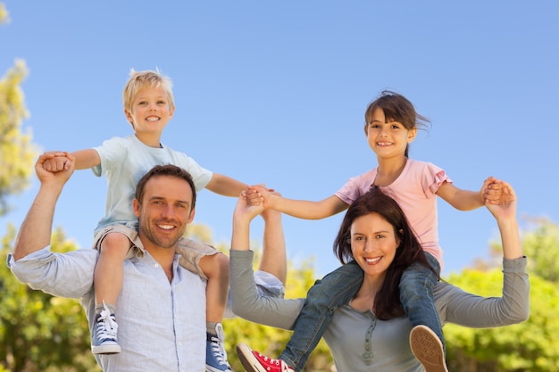 Parents giving  children a piggyback 