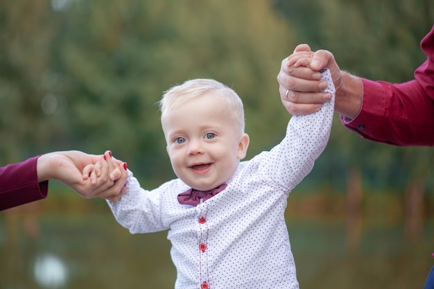 Photo parents hold baby hands. happy family concept