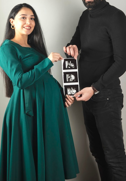 Parents hold ultrasound picture of baby