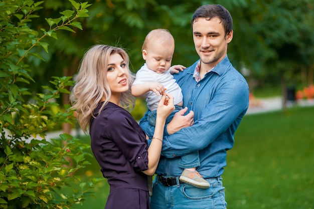 Parents holding a child in the Park