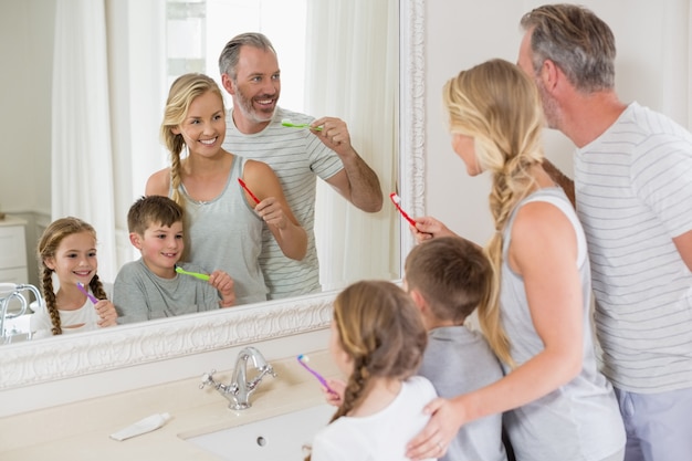 Parents and kids brushing teeth in bathroom