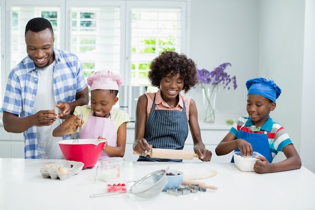 Parents and kids preparing food in kitchen