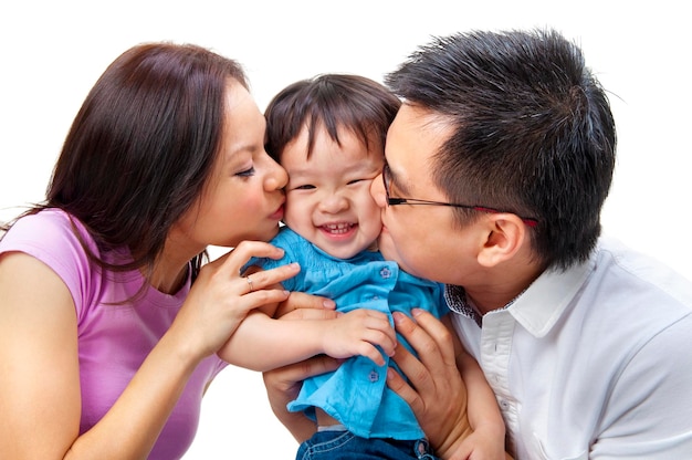 Photo parents kissing cute daughter against white background