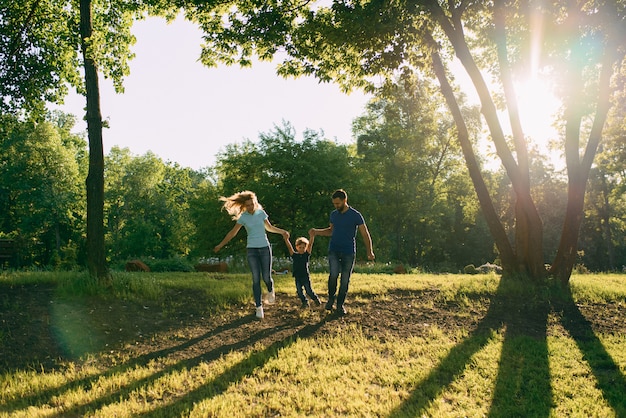 Parents play in the park with their son