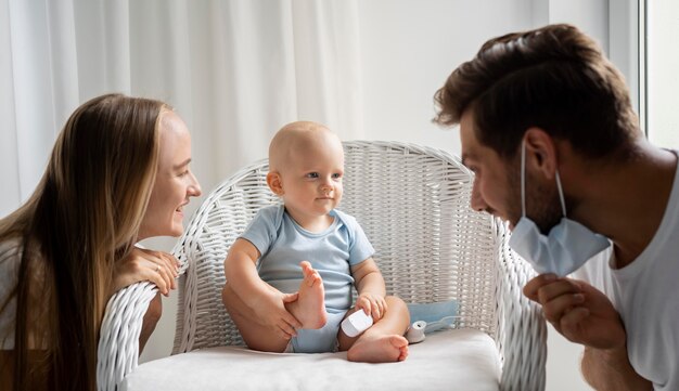 Photo parents playing with child at home during quarantine