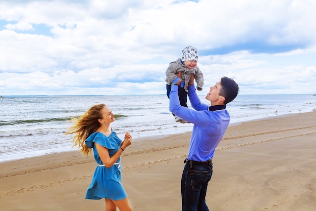 Parents playing with his son on the beach