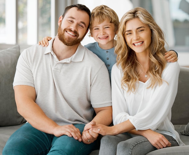 Parents portrait and couch with hug son and smile with love bonding and care in family home together Father mother and boy child with happiness embrace and relax on living room sofa in house