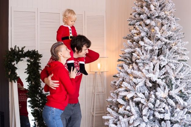 Parents present gift box to their baby boy son on Christmas