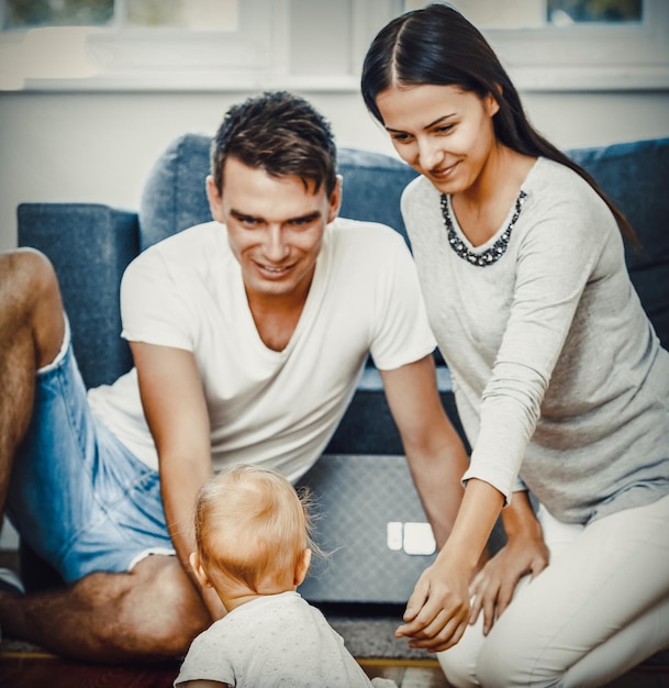 Parents with baby in living room at home