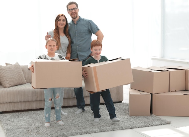 Photo parents with their children moves the boxes to a new apartmentphoto with copy space