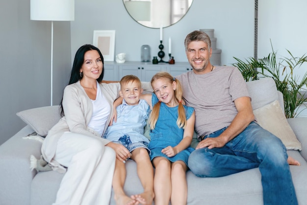 Parents with two children sitting on a comfortable sofa