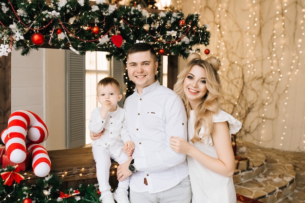 parents with a young son on the background of a Christmas bar