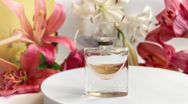 Parfum with flowers on white background a perfume bottle surrounded by lilies petals in pink and