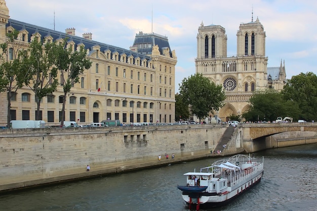 Paris France August 26 2018 Tourists enjoy a boat trip on Seine river near Notre Dame cathedral