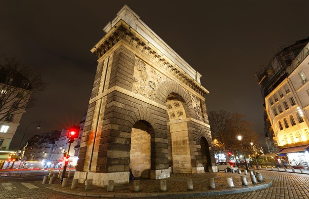 Paris the porte SaintMartin beautiful ancient gate near the Grands Boulevards at night