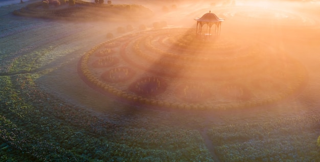 Park gazebo in the fog at dawn