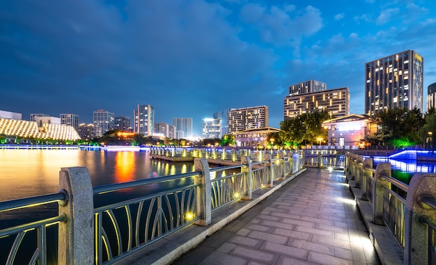 公園の湖と近代的な都市建築の風景の夜景