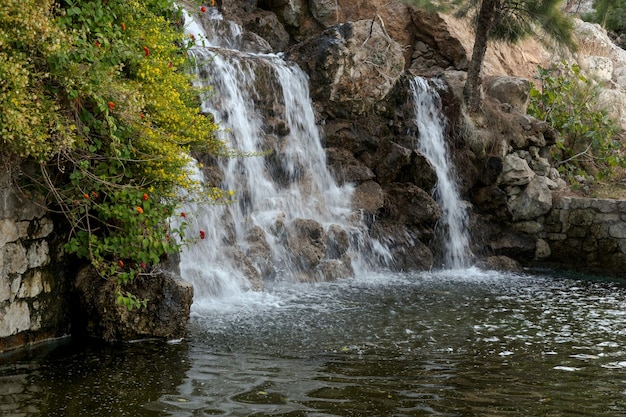 Park landscape design Cascades of the waterfall in the park in the evening autumn day