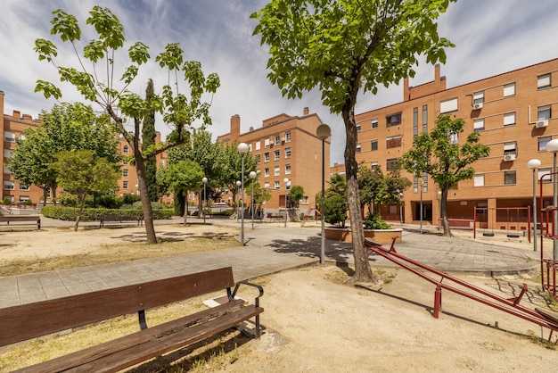 A park with a bench and trees in the background