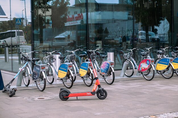 Parked bicycles and an electric scooter near the office building May 27 2022 Warsaw Poland