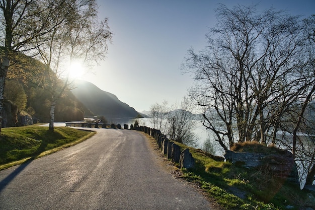 Parking lot overlooking the road the Nordfjord and Bergen in Norway Sun rays