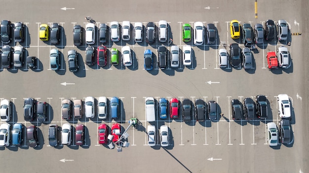 Parking lot with many cars aerial top drone view from above, city transportation and urban concept