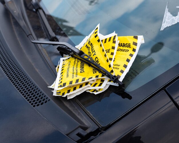 Photo parking tickets left on the windscreen of a vehicle