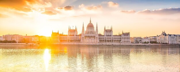 Parliament building over delta of Danube river in Budapest Hungary at sunset