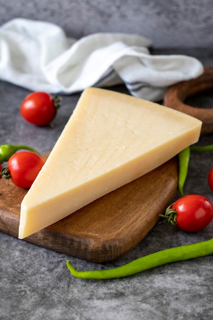 Parmesan cheese Italian parmesan cheese on a wooden serving platter close up