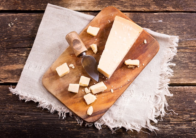 Parmesan cheese on old wooden board