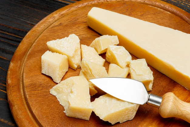 Parmesan cheese on wooden background