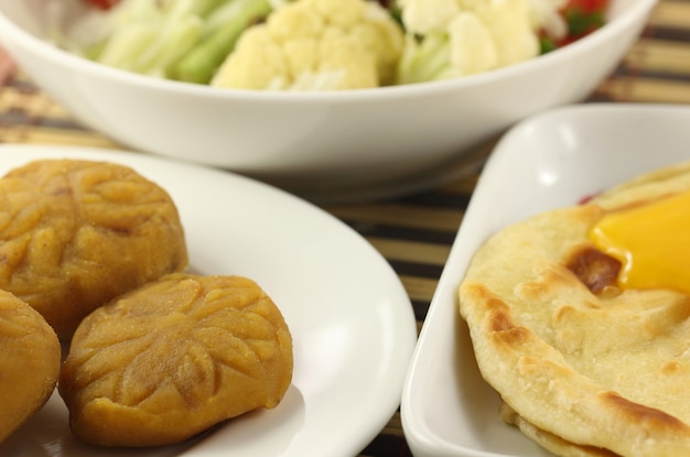 Parotta with barfi and vegetables close up