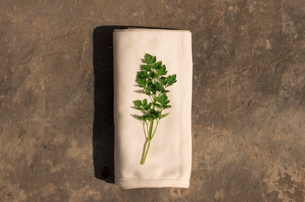 Photo parsley on a white cloth on stone