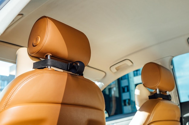 Photo part of brown leather car seat with the unfocused car