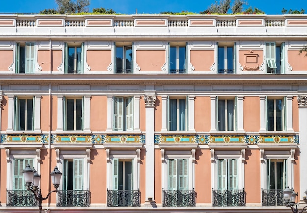 Part of buildings on local road in Monaco under cloudy blue sky