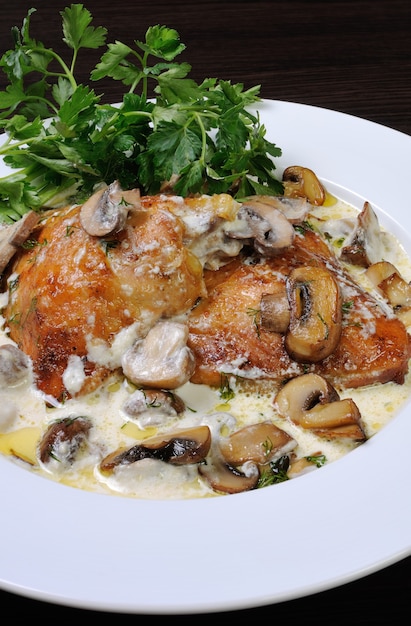 Part of the chicken in a creamy sauce with mushrooms