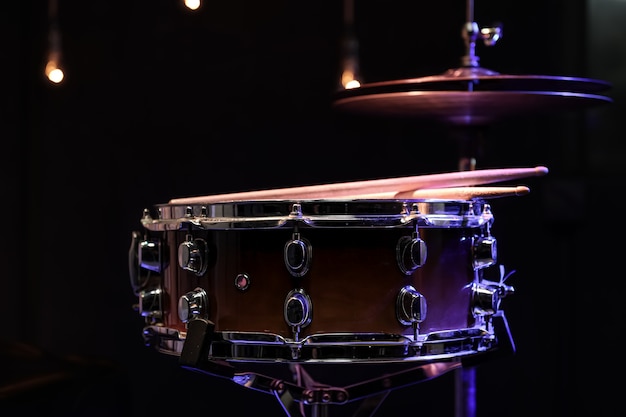 Part of a drum kit close up in the dark copy space.