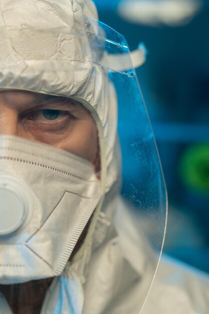 Part of face of male scientist in protective medical\
workwear