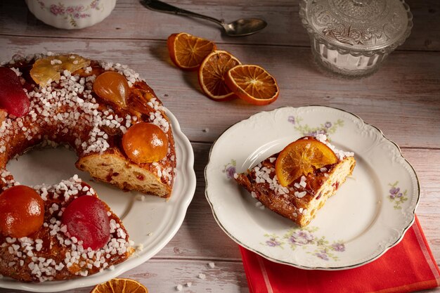 Part of a king's cake, brioche with candied fruits for the Epiphany on a vintage plate