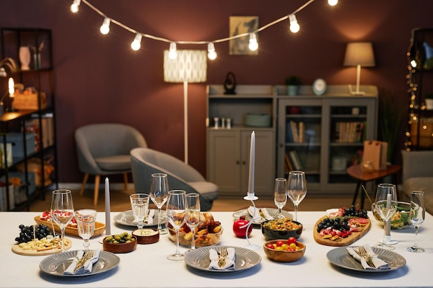 Part of large dinner table with variety of homemade food prepared for guests