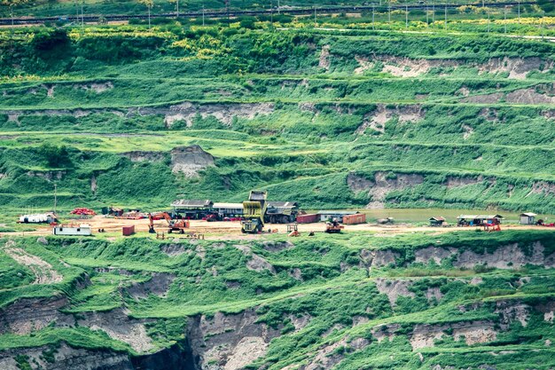 Photo part of a pit with big mining truck working